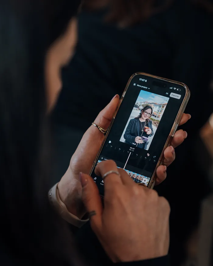 Mãos a rever no telemóvel a fotografia acabada de tirar.